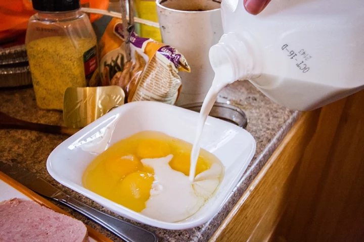 milk being poured raw eggs