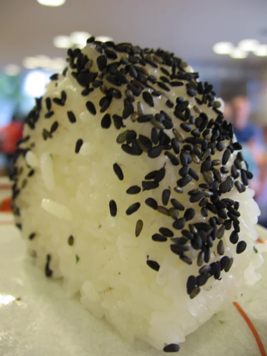 an onigiri without the nori covered in black sesame seeds